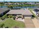 Aerial view of a beautifully landscaped one-story home with a large driveway and waterfront access at 1229 Waterside Ln, Venice, FL 34285