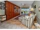 Office with built-in shelves, ceiling fan, and sliding glass doors to pool at 1229 Waterside Ln, Venice, FL 34285