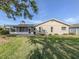 Spacious backyard featuring a patio, screened-in porch, and a well-maintained lawn at 1234 Pinebrook Way, Venice, FL 34285