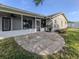 Backyard with large patio, grill, screened-in porch and lush green lawn at 1234 Pinebrook Way, Venice, FL 34285