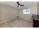 Neutral bedroom with tile floors, ceiling fan, and natural light from one window at 1234 Pinebrook Way, Venice, FL 34285