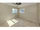 Neutral bedroom with tile floors, ceiling fan, and natural light from two windows at 1234 Pinebrook Way, Venice, FL 34285
