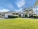 Charming single-story home with a well-manicured front lawn and lush landscaping at 1234 Pinebrook Way, Venice, FL 34285