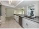 Bright kitchen featuring white cabinets, a stainless steel sink, and a spacious island at 1234 Pinebrook Way, Venice, FL 34285
