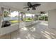 Spacious enclosed patio with tile flooring, ceiling fans, and easy access to the backyard at 1234 Pinebrook Way, Venice, FL 34285