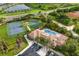 Aerial view of tennis and basketball courts, community pool, and clubhouse at 1254 Cielo Ct, North Venice, FL 34275