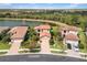 Aerial view of the home showcasing its tile roof, landscaping, and lakeside location at 1254 Cielo Ct, North Venice, FL 34275
