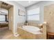 Bathroom featuring a tiled shower and soaking tub at 1254 Cielo Ct, North Venice, FL 34275