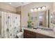 Bright bathroom with a shower and tub combination, granite countertop, and decorative accents at 1254 Cielo Ct, North Venice, FL 34275