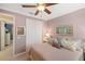 Comfortable bedroom with a ceiling fan, closet space, and soft lighting at 1254 Cielo Ct, North Venice, FL 34275