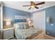 Comfortable bedroom featuring coastal decorations, a ceiling fan and ample window light at 1254 Cielo Ct, North Venice, FL 34275