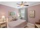 Charming bedroom featuring a ceiling fan, a comfortable bed, and soft, neutral colors at 1254 Cielo Ct, North Venice, FL 34275