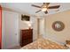 Comfortable bedroom with ceiling fan and view to the hallway and bathroom at 1254 Cielo Ct, North Venice, FL 34275
