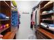 Custom walk-in closet with built-in shelving and organized clothing storage at 1254 Cielo Ct, North Venice, FL 34275