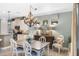 Charming dining area features a wooden table, chandelier lighting, and direct access to the kitchen at 1254 Cielo Ct, North Venice, FL 34275