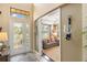 Inviting foyer features decorative glass door, soaring ceilings, and a glimpse into the elegant living room at 1254 Cielo Ct, North Venice, FL 34275