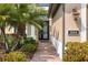 Inviting front door entrance with lush tropical landscaping and brick walkway at 1254 Cielo Ct, North Venice, FL 34275