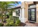 Elegant front door with decorative glass, framed by lush landscaping and a welcoming exterior at 1254 Cielo Ct, North Venice, FL 34275