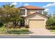 Two-story home with a brick driveway, tile roof, and lush landscaping at 1254 Cielo Ct, North Venice, FL 34275