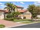 Charming home with lush tropical landscaping, a paved driveway, and a tile roof at 1254 Cielo Ct, North Venice, FL 34275
