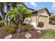 Landscaped front yard with flowering shrubs and a paved driveway leads to the garage at 1254 Cielo Ct, North Venice, FL 34275