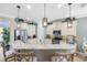 Bright kitchen showcases granite countertops, stainless steel appliances, and stylish pendant lighting above breakfast bar at 1254 Cielo Ct, North Venice, FL 34275