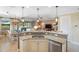 Open-concept kitchen with granite countertops, stainless steel appliances, and seamless flow to dining and living areas at 1254 Cielo Ct, North Venice, FL 34275