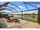 Screened lanai with comfortable seating and stunning view of the lake, perfect for relaxing at 1254 Cielo Ct, North Venice, FL 34275