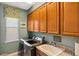 Efficient laundry room equipped with modern washer/dryer units and ample cabinet storage at 1254 Cielo Ct, North Venice, FL 34275