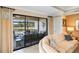 Living room featuring sliding glass doors leading to a screened in patio with seating at 1254 Cielo Ct, North Venice, FL 34275