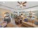 An open concept living room with an adjoining kitchen and large, decorative ceiling fan at 1254 Cielo Ct, North Venice, FL 34275