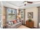 Bright living room features tray ceilings, large windows with custom curtains, and comfortable seating at 1254 Cielo Ct, North Venice, FL 34275