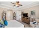 Main bedroom boasts a comfortable chair, dresser, and views to the ensuite bathroom at 1254 Cielo Ct, North Venice, FL 34275
