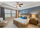 Main bedroom with a large window, tray ceiling, and modern furniture at 1254 Cielo Ct, North Venice, FL 34275