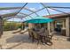 Relaxing patio with a seating area and dining space under the screened enclosure at 1254 Cielo Ct, North Venice, FL 34275