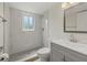 Clean bathroom with marble-look tile, a gray vanity, and a mosaic tile shower floor at 1258 Barbara Dr # 105, Venice, FL 34285