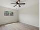 Bedroom with tile floors, a ceiling fan, and a window providing natural light at 1258 Barbara Dr # 105, Venice, FL 34285