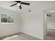 Bedroom features tile floors, a ceiling fan, a window and access to another room at 1258 Barbara Dr # 105, Venice, FL 34285