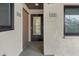 Building entrance featuring unit numbers, window, and a view to the interior at 1258 Barbara Dr # 105, Venice, FL 34285