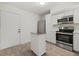 This modern kitchen features stainless appliances, light countertops, and a kitchen island at 1258 Barbara Dr # 105, Venice, FL 34285
