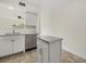 Bright kitchen with stainless appliances, neutral countertops, and a compact island for prep at 1258 Barbara Dr # 105, Venice, FL 34285