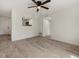 Living room with tile floors and lots of natural light with an open view to the kitchen at 1258 Barbara Dr # 105, Venice, FL 34285
