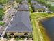 Overhead shot highlighting the building's proximity to the lake and parking near lush landscaping at 12983 Tigers Eye Dr, Venice, FL 34292