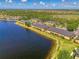 Scenic aerial view of waterfront townhome community with lush greenery along the lake at 12983 Tigers Eye Dr, Venice, FL 34292