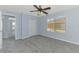 Light blue bedroom with large window and closet with neutral carpeting at 12983 Tigers Eye Dr, Venice, FL 34292
