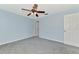 Bedroom showing the light blue walls, neutral carpet, and ceiling fan with light at 12983 Tigers Eye Dr, Venice, FL 34292