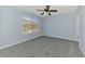 Bedroom featuring neutral walls, ceiling fan, and a large window bringing in natural light at 12983 Tigers Eye Dr, Venice, FL 34292
