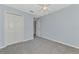 This carpeted bedroom is painted blue and has a closet at 12983 Tigers Eye Dr, Venice, FL 34292