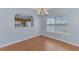 Inviting dining area with lake view, laminate flooring, and an open view to the kitchen at 12983 Tigers Eye Dr, Venice, FL 34292