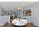 Stylish dining room featuring a modern table with seating for four and a view into the kitchen at 12983 Tigers Eye Dr, Venice, FL 34292